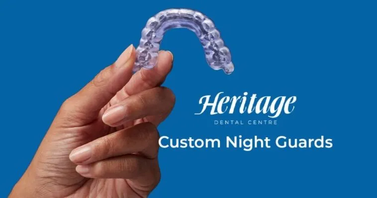 Flexible clear night guard being held in hand for dental protection at Heritage Dental Centre.