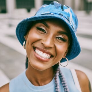 Edmonton Family Dentists | Heritage Dental Centre 13 Girl wearing a bucket hat with white teeth smiling