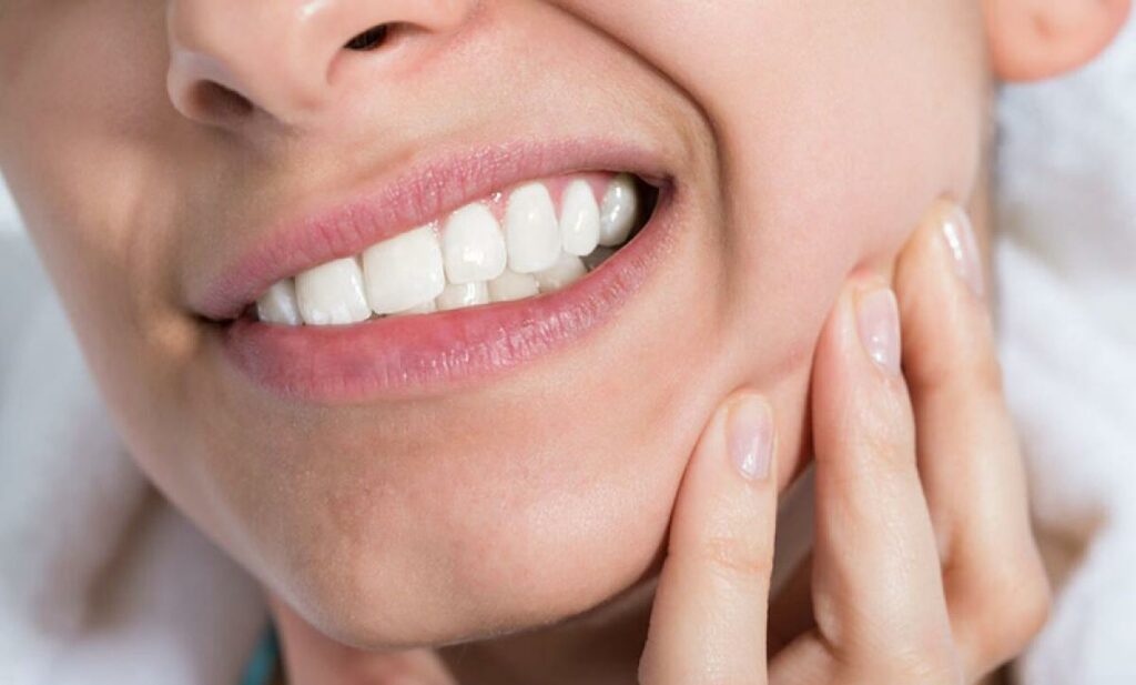 Person with sore jaw due to teeth grinding