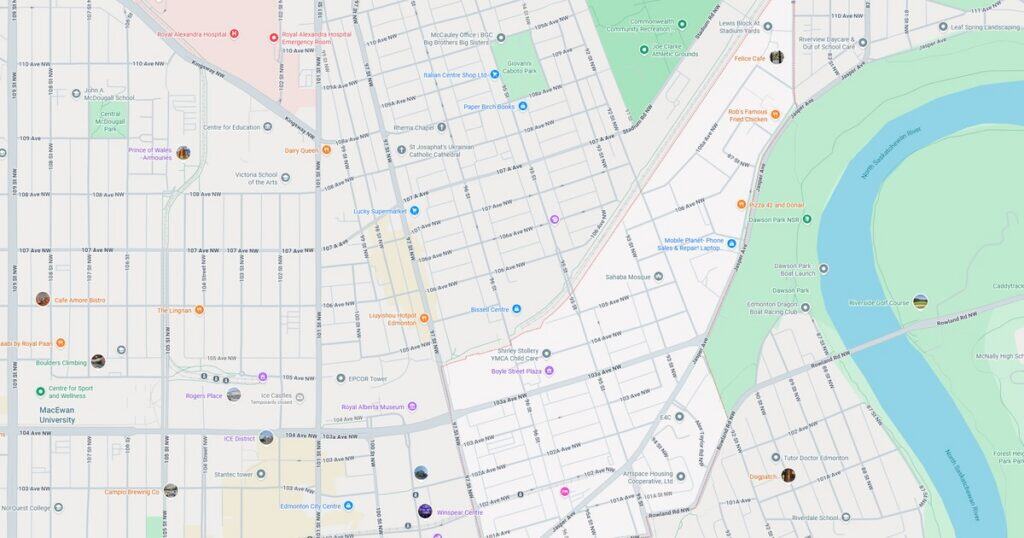 Detailed city map highlighting major streets, parks, and landmarks in downtown area. Includes river, public transportation routes, and points of interest for navigation.